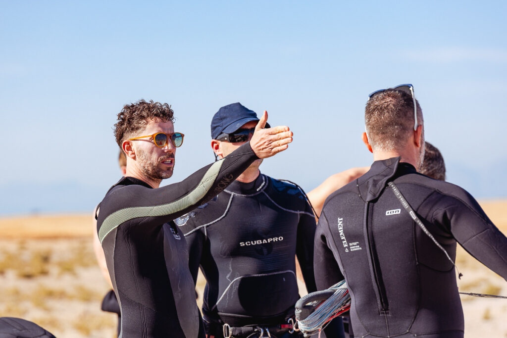 International gay kitesurfers sharing laughs on the boat deck