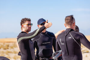 International gay kitesurfers sharing laughs on the boat deck